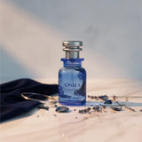 Soghaat Osma Paudree F Eau de Parfum bottle with floral and musk notes, silver cap, blue glass.