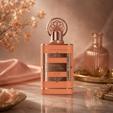 Soghaat Peachy Haze by Adyan Anfar extrait de parfum in a peach-coloured bottle with ornate gold cap on marble surface.