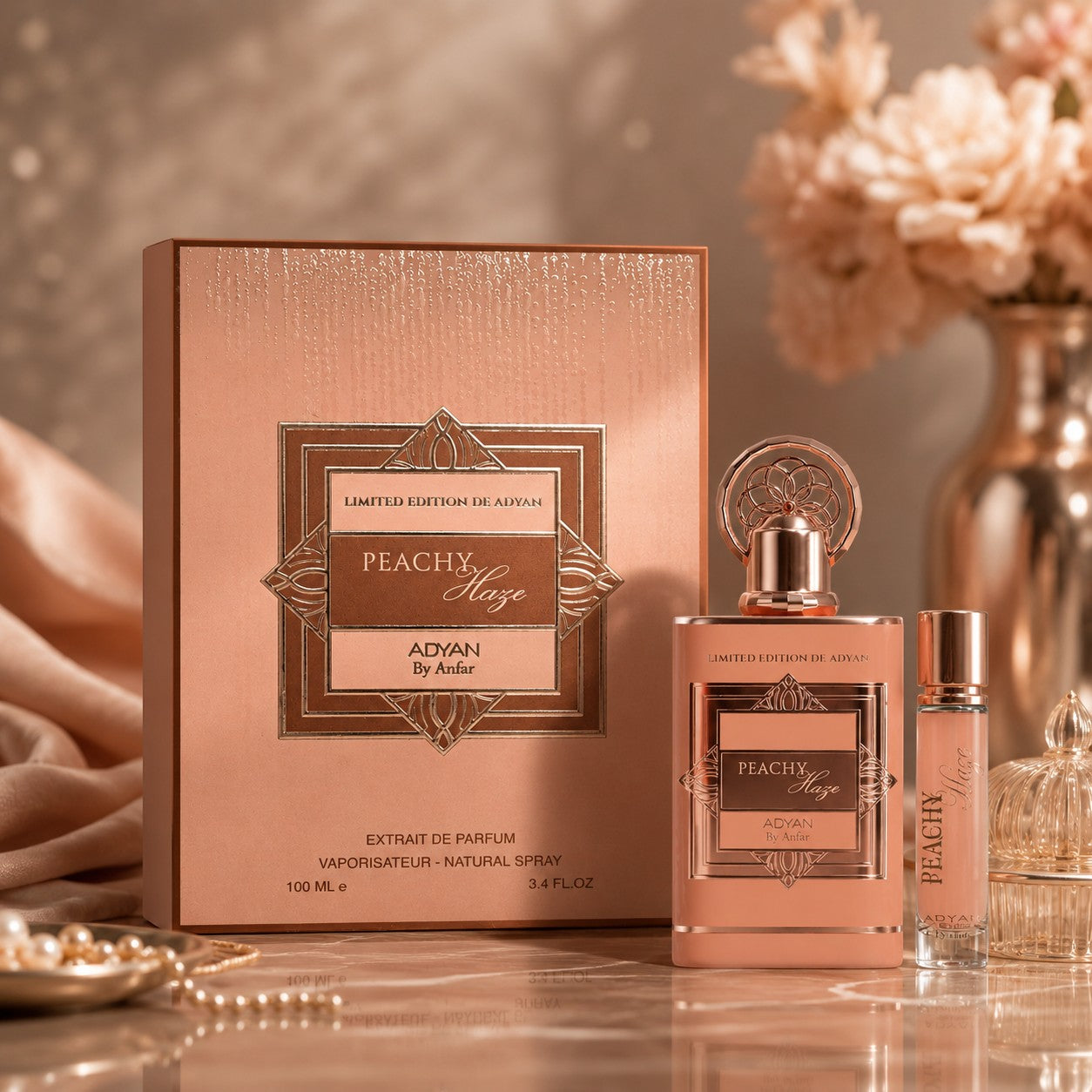 Soghaat Peachy Haze by Adyan Anfar Extrait de Parfum set with a peach-coloured bottle and box on a marble surface.
