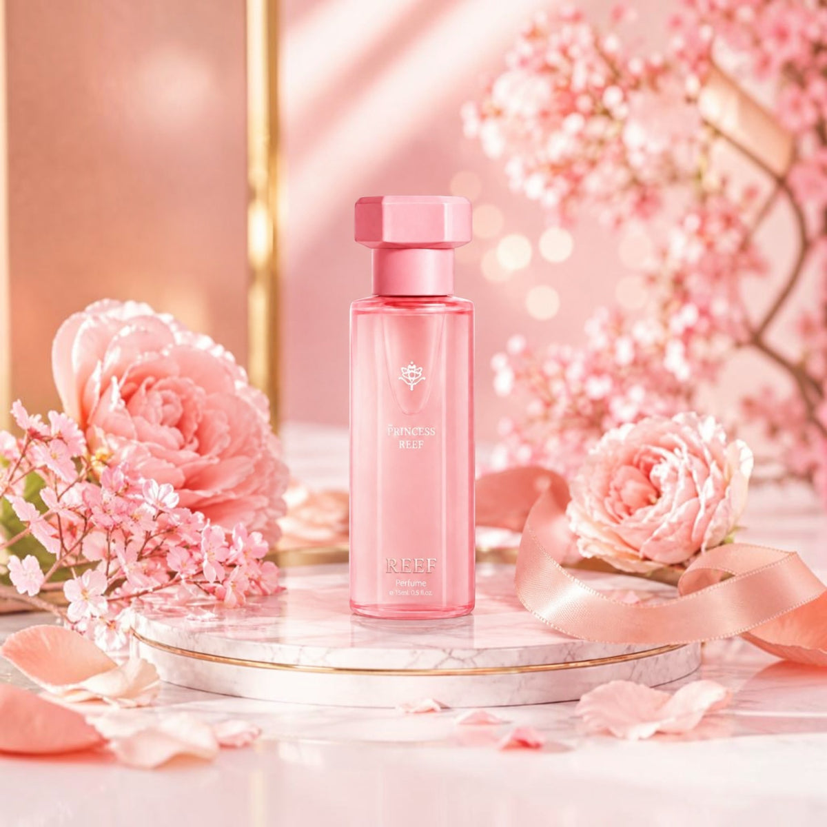 Soghaat Princess Reef perfume bottle in pink glass on a marble pedestal surrounded by soft pink flowers and petals.