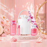 Soghaat Princess Reef perfume gift set featuring three pink bottles and a white handbag on a marble pedestal.