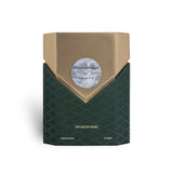 Soghaat Prometheus 100ml Extrait de Parfum bottle with gold and dark green textured design. Unisex woody aromatic fragrance.