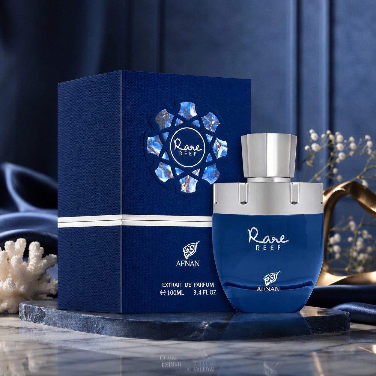 Soghaat Rare Reef by Afnan 100ml Extrait de Parfum in a deep blue bottle and matching box on a marble display.