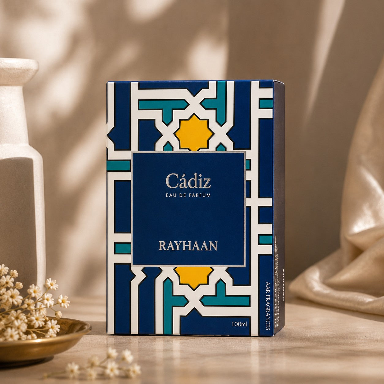 Soghaat Rayhaan Cadiz Eau de Parfum 100ml, amber woody oriental fragrance with blue and gold geometric pattern.