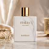 Rayhaan Italia Eau de Parfum by Soghaat in a white marble-effect bottle with gold cap, featuring amber gourmand scent.