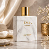 Soghaat Rayhaan Italia Eau de Parfum in a white marble-effect bottle with a gold cap, set on a marble surface.