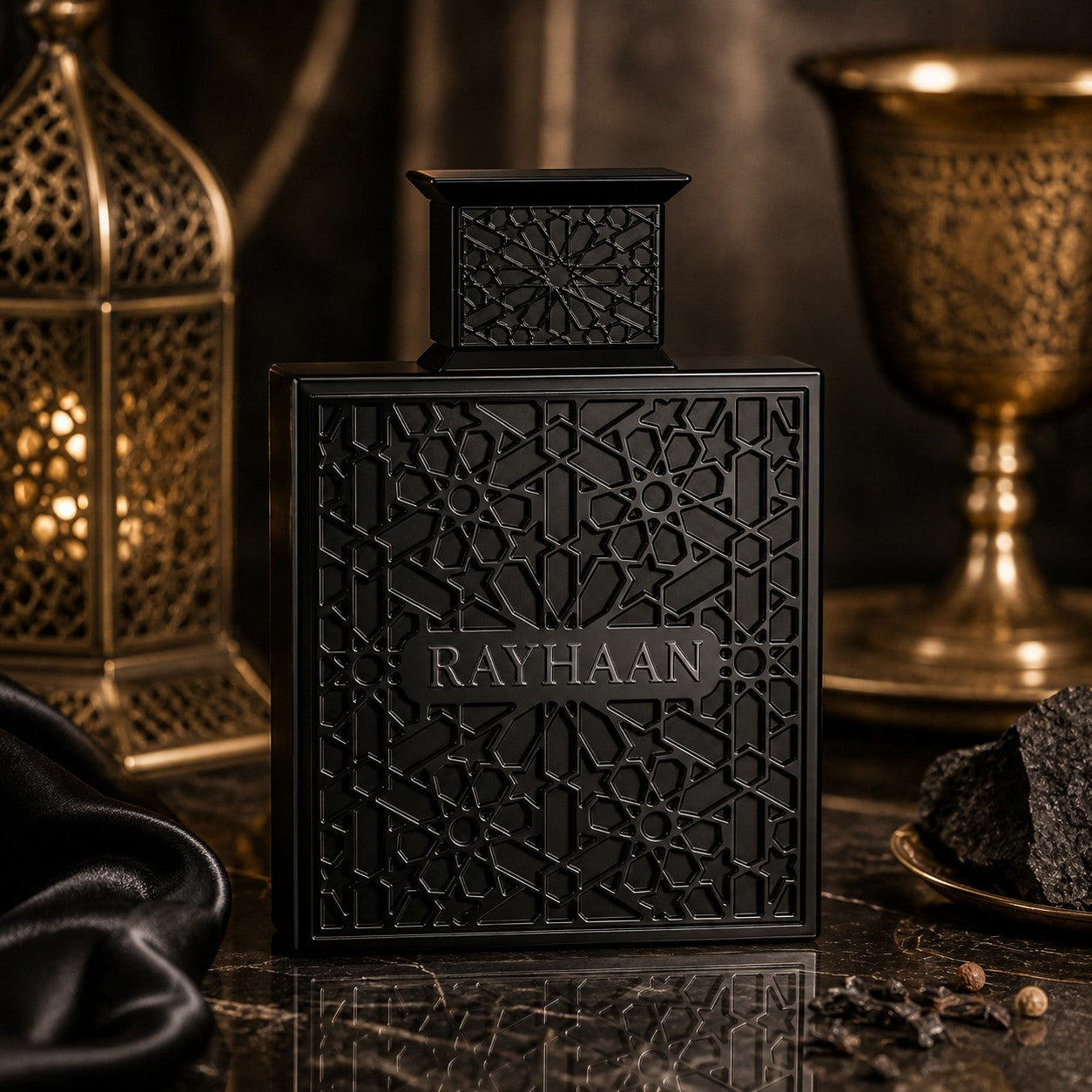 Rayhaan Obsidian Eau de Parfum by Soghaat in a black, intricately patterned bottle on a dark marble surface.