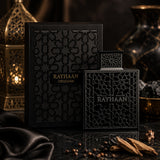 Soghaat Rayhaan Obsidian Eau de Parfum bottle and box with intricate black geometric patterns on a dark surface.