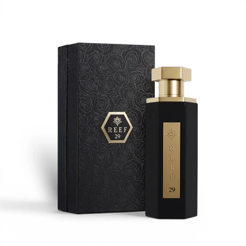 Soghaat Reef 29 unisex Eau de Parfum in a black hexagonal bottle with a gold cap, next to its matching floral box.