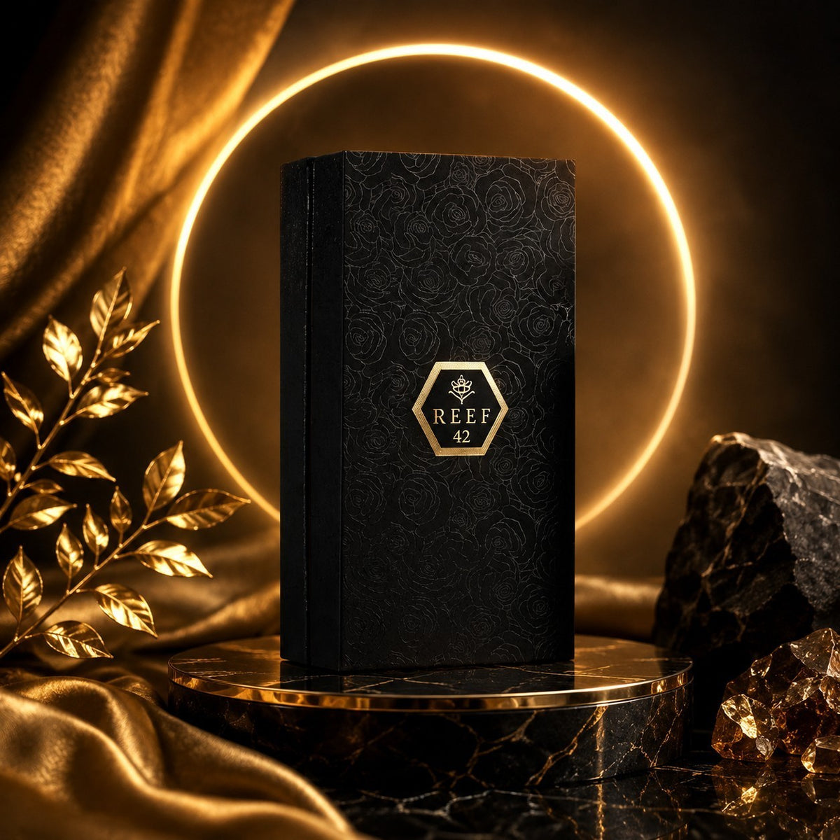 Soghaat Reef 42 Eau de Parfum in a black embossed box on a marble pedestal with gold accents and a glowing ring light.