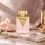 Soghaat Rhea Extrait de Parfum by Ahmed Al Maghribi in a pink quilted glass bottle with gold accents on a marble base.