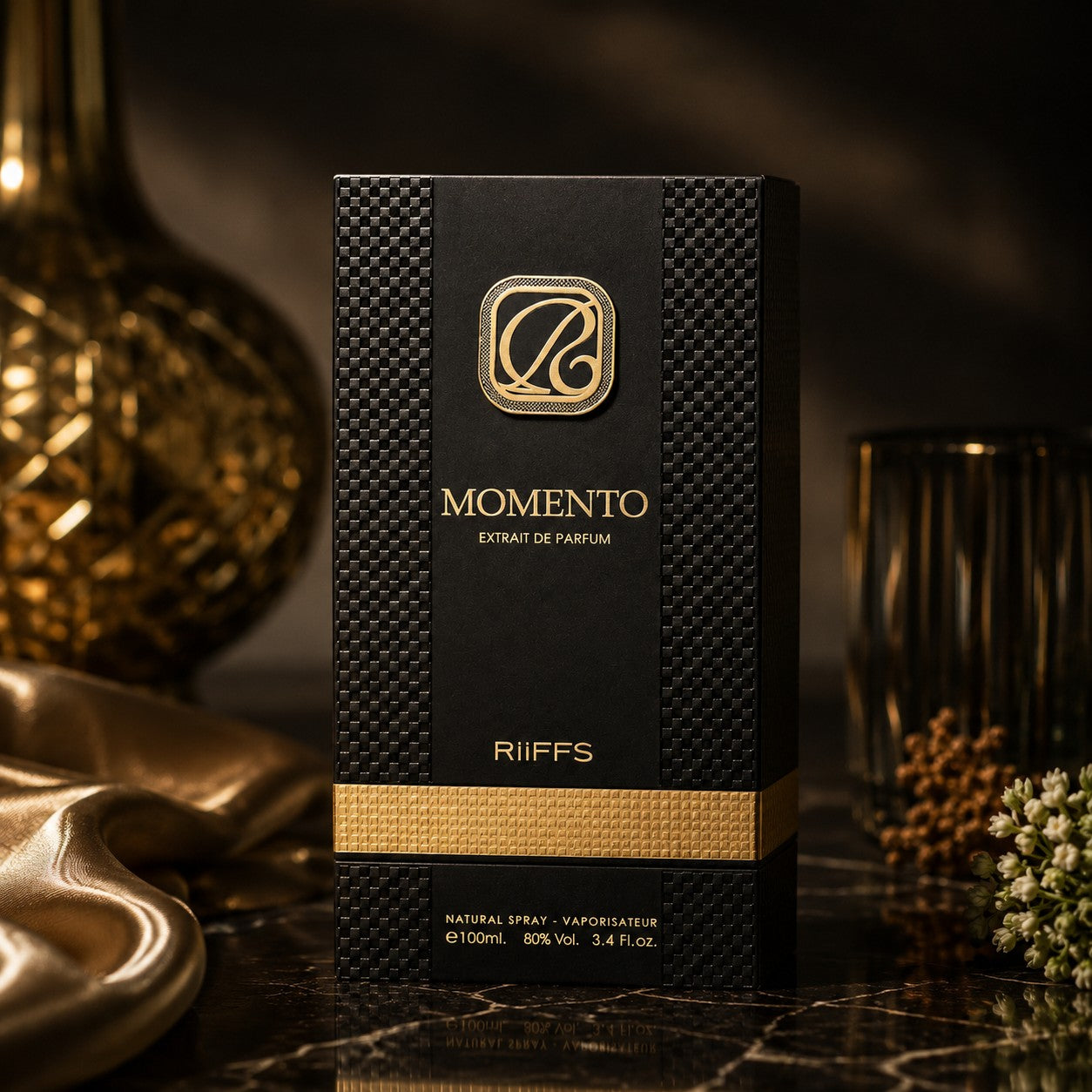 Soghaat RiiFFS Momento 100ml Extrait de Parfum in a luxury black and gold textured box on a dark marble surface.