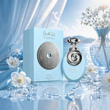 Soghaat Riiffs Tahira 100ml Extrait de Parfum bottle and box in light blue, set against a serene coastal backdrop.