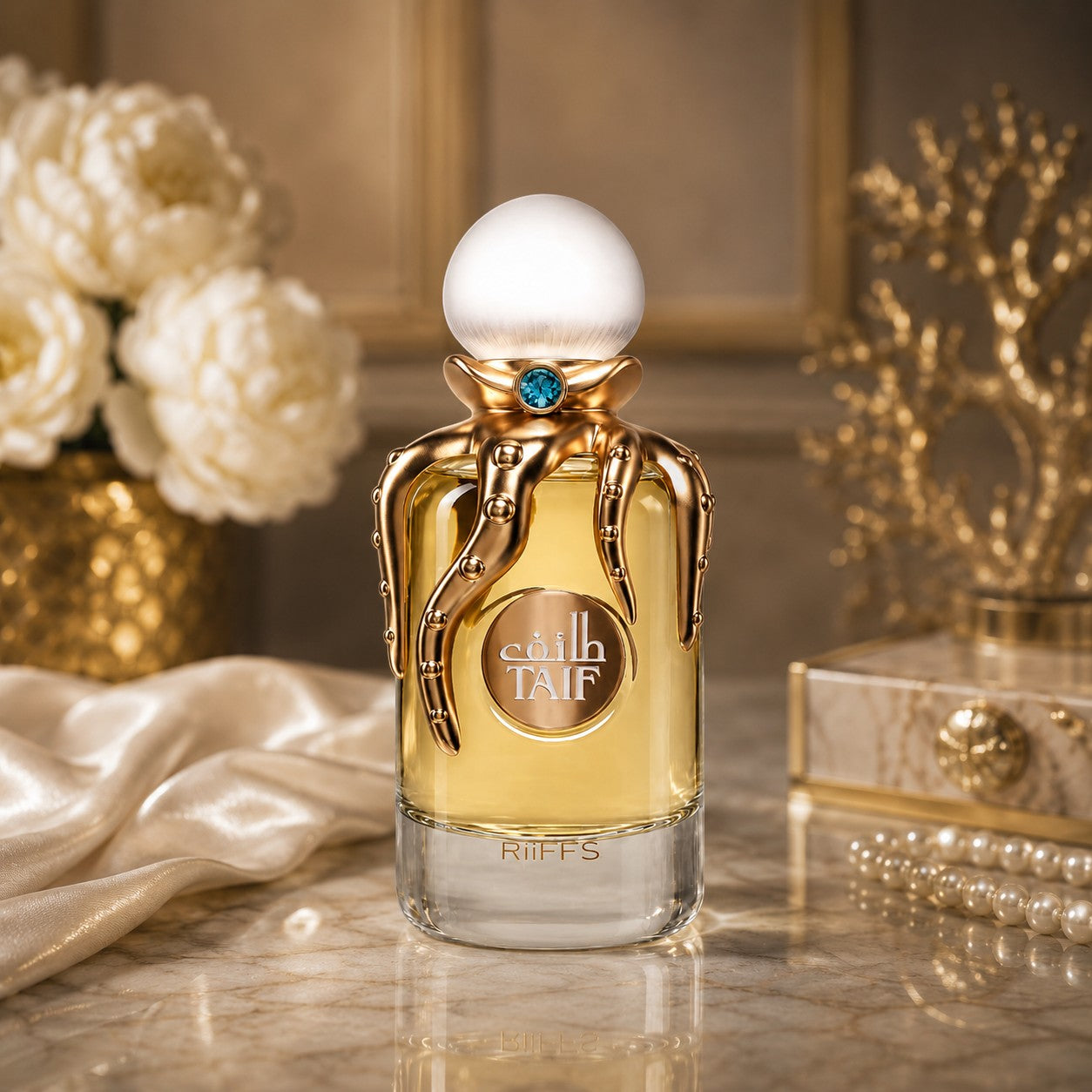 Soghaat RiiFFS Taif Extrait de Parfum in a unique gold octopus-themed bottle with a white cap on a marble surface.