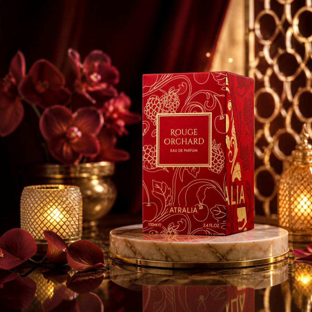 Soghaat Rouge Orchard by Atralia 100ml Eau de Parfum box in red with gold floral patterns on a marble display stand.