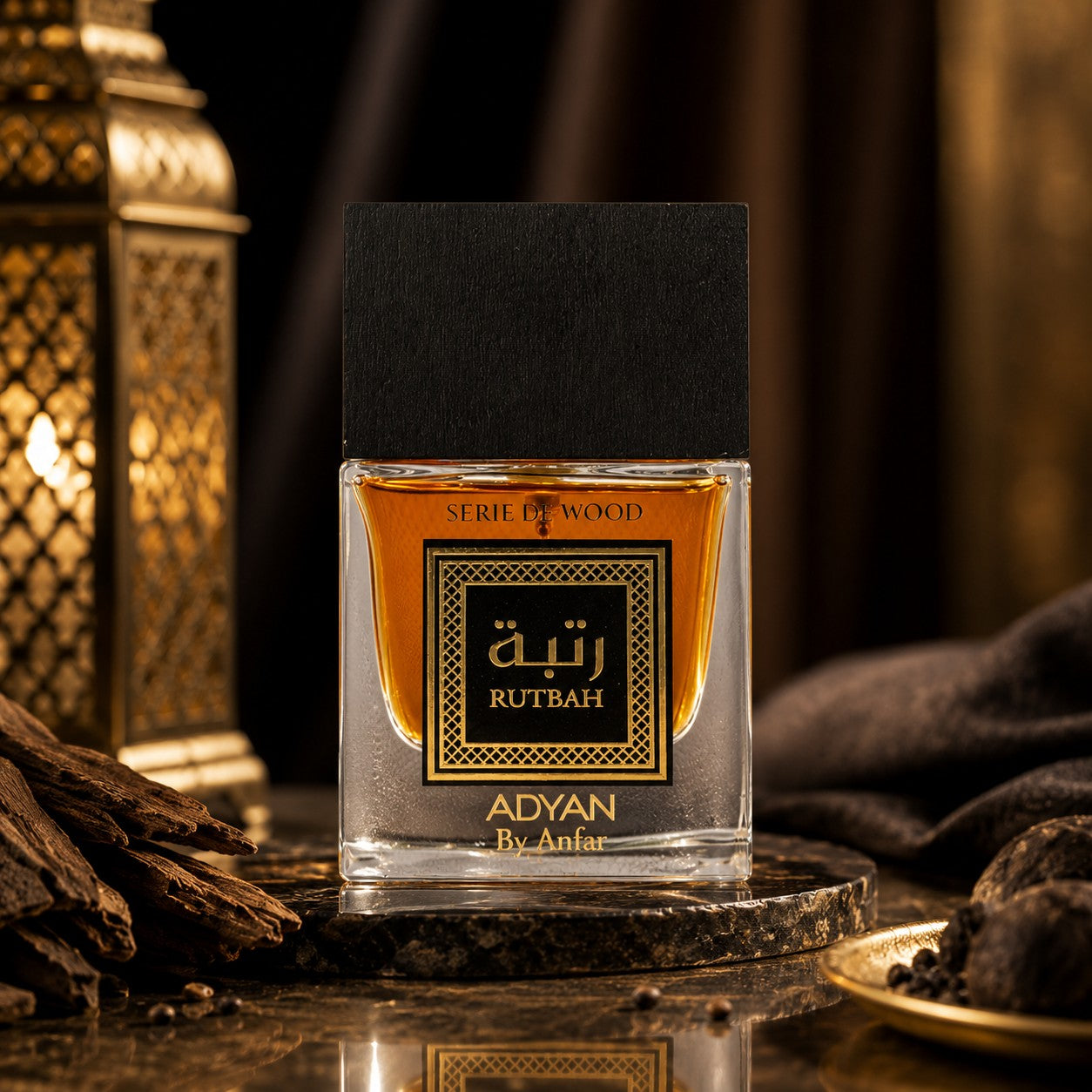 Soghaat Rutbah Adyan by Anfar 100ml Extrait de Parfum in a glass bottle with a black cap on a dark marble surface.