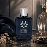 Soghaat Sedley Eau de Parfum for men, a fresh woody aromatic fragrance in a blue glass bottle with a silver cap.