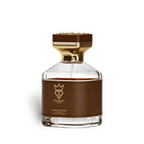 Soghaat Smokilla 100ml Extrait de Parfum, a unisex amber woody oriental fragrance with tobacco leaf, vanilla, and woody notes, presented in a clear glass bottle with brown leather accent.