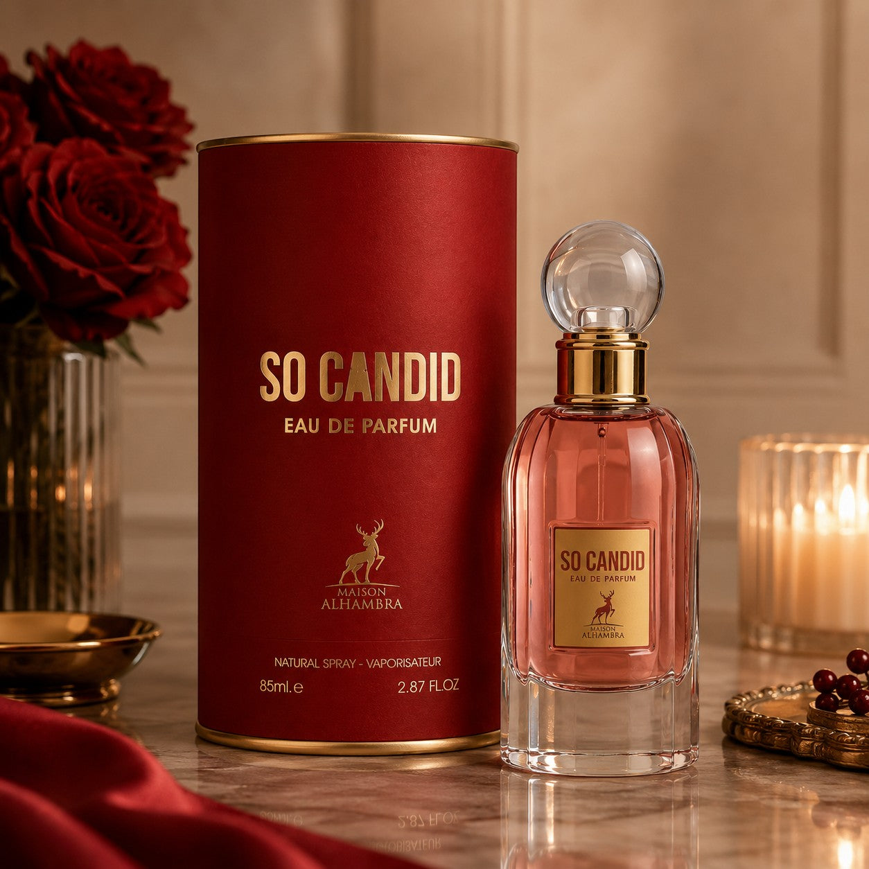 Soghaat Maison Alhambra So Candid 85ml Eau de Parfum bottle and red cylindrical box with gold lettering on a table.