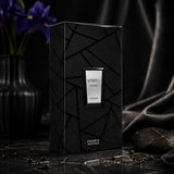 Soghaat French Avenue Spirito Ignite Extrait de Parfum box with geometric black pattern, iris flowers, and dark decor.
