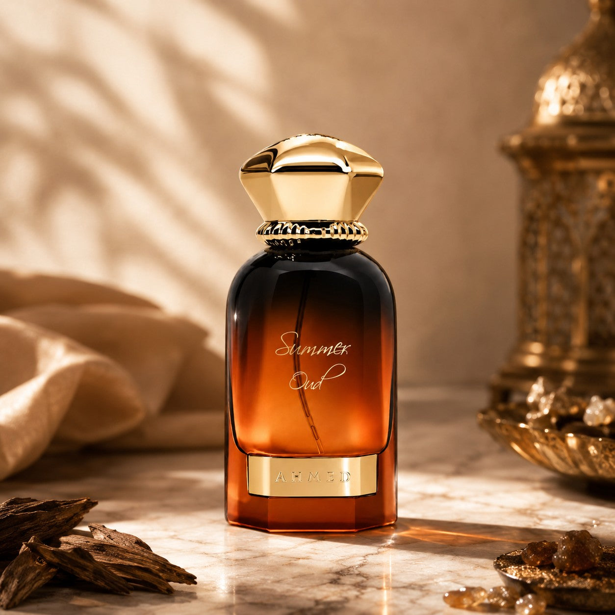 Soghaat Ahmed Al Maghribi Summer Oud Eau de Parfum in a gradient amber glass bottle with a gold cap on a marble surface.