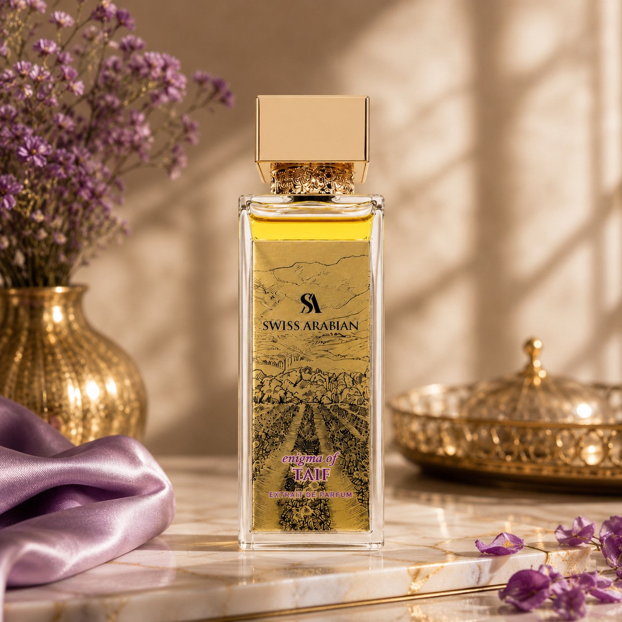 Soghaat Swiss Arabian Enigma of Taif Extrait de Parfum bottle with gold cap on a marble surface with purple flowers.