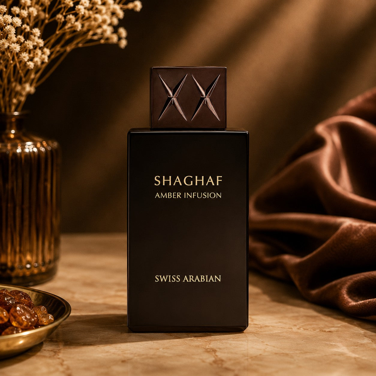Soghaat Swiss Arabian Shaghaf Amber Infusion Eau de Parfum in a sleek black bottle with a textured cap on a table.