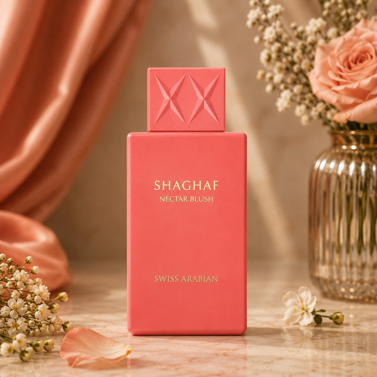 Soghaat Swiss Arabian Shaghaf Nectar Blush Eau de Parfum in a vibrant pink bottle with gold lettering on a marble table