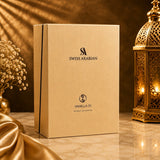 Soghaat Swiss Arabian Vanilla 01 Extrait de Parfum box on a marble table with a golden lantern and silk fabric.