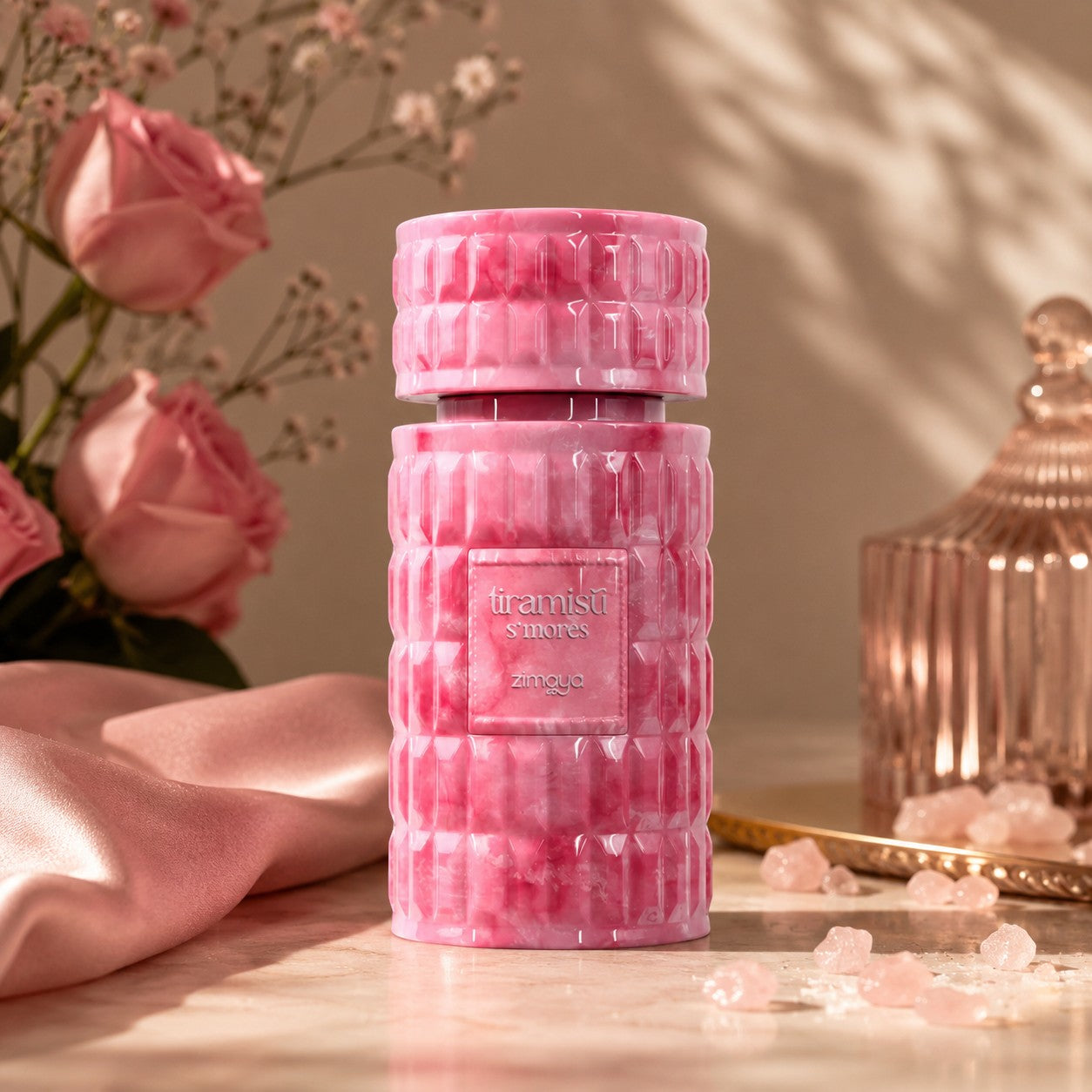 Soghaat Zimaya Tiramisu S'mores Eau de Parfum in a pink marble-effect bottle with a textured, geometric design.
