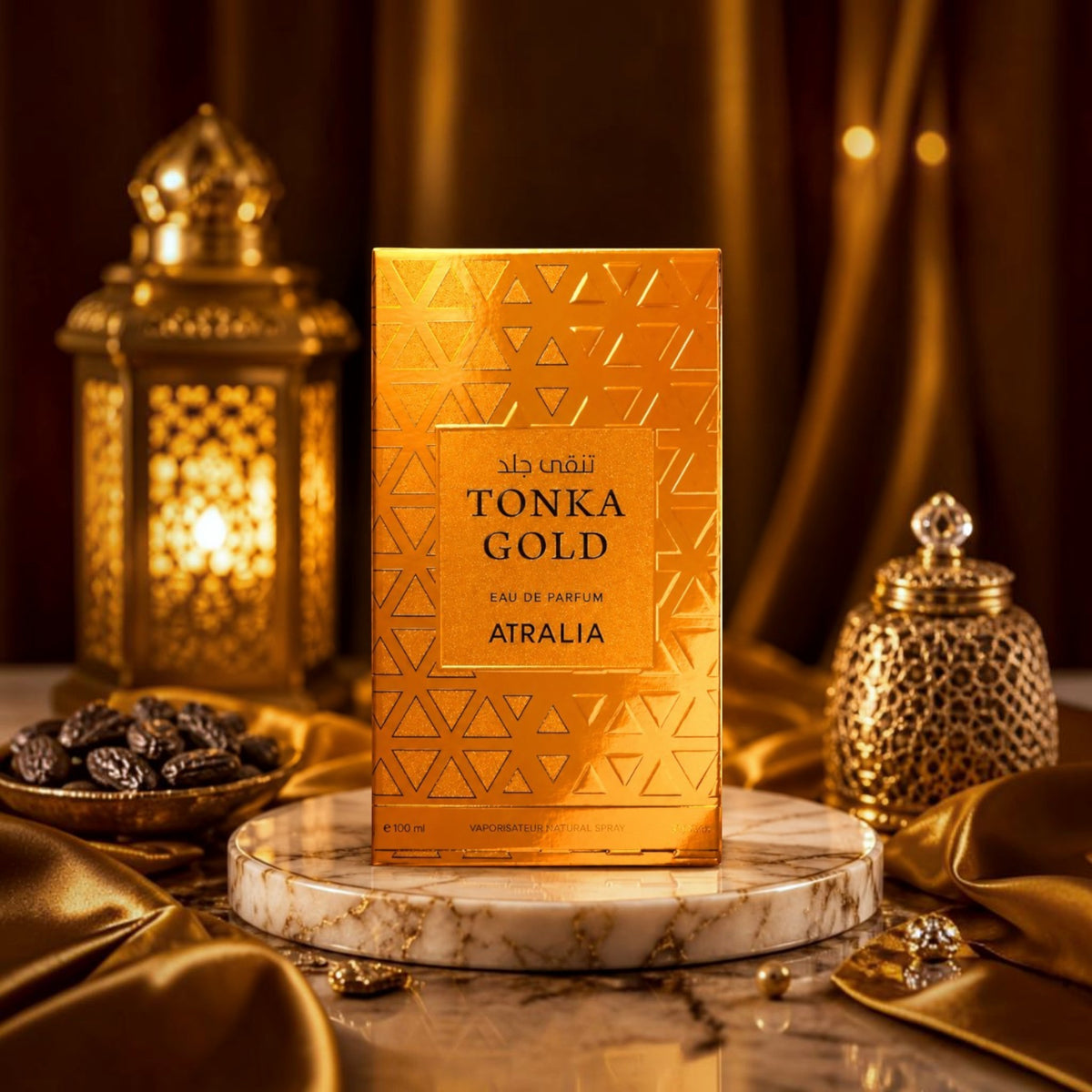 Soghaat Tonka Gold by Atralia 100ml Eau de Parfum in a gold box on a marble stand with Arabian lanterns and dates.
