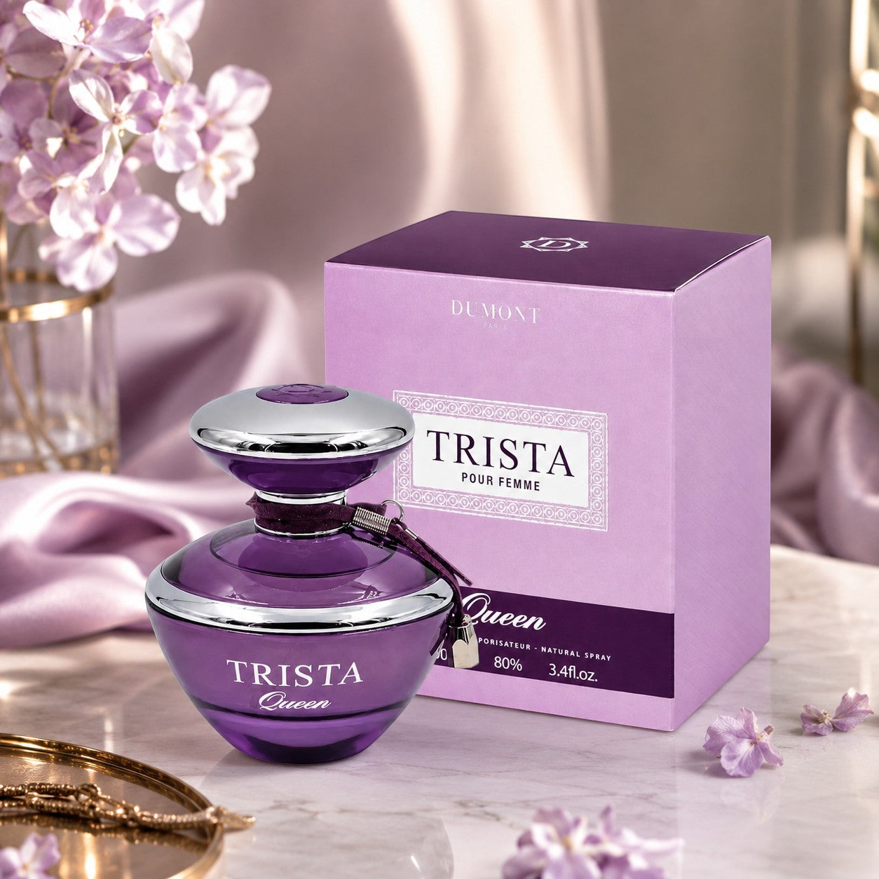 Soghaat Dumont Paris Trista Queen Eau de Parfum bottle and purple box on a marble table with flowers.