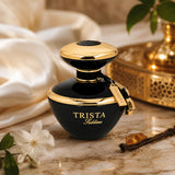 Soghaat Trista Sublime Eau de Parfum bottle in black and gold, featuring floral notes on a marble surface.