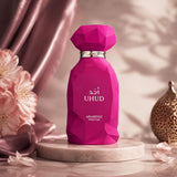 Soghaat Uhud 100ml Eau de Parfum, a sweet amber gourmand fragrance in a faceted fuchsia bottle with gold accents.