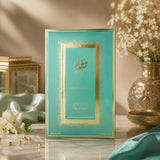 Soghaat Wafa by Adyan Anfar 100ml Extrait de Parfum in a teal and gold box on a marble surface with floral decor.