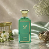 Soghaat Wafa by Adyan Anfar Extrait de Parfum in a green glass bottle with gold accents, styled with silk and flowers.