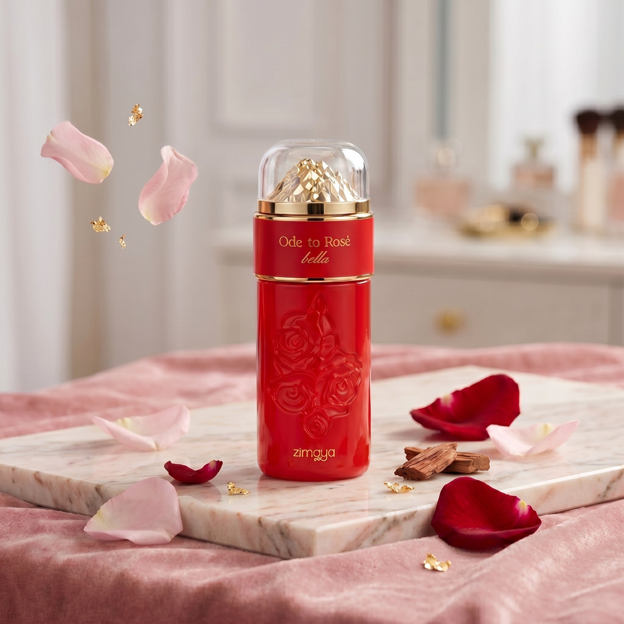 Soghaat Zimaya Ode to Rose Bella 100ml Eau de Parfum bottle surrounded by rose petals and gold flakes on a marble tray.