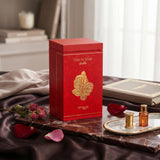 Soghaat Zimaya Ode to Rose Bella 100ml Eau de Parfum in a red box with gold rose detail on a marble tray with petals.