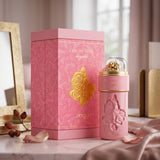 Soghaat Zimaya Ode To Rose Royale Eau de Parfum bottle and pink patterned gift box on a marble table.