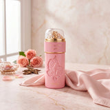 Soghaat Zimaya Ode To Rose Royale Eau de Parfum in a pink bottle with rose embossing, set on a marble table with roses.